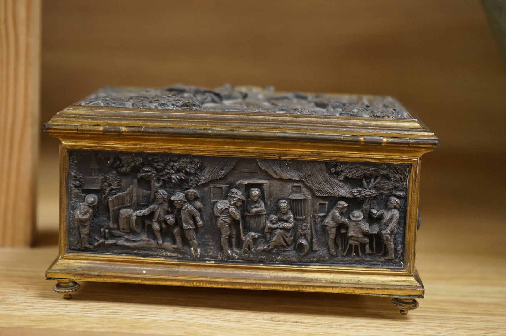 A late 19th century French gilt copper jewellery casket with electrotype relief panels, stamped A B Paris to the base, with key, 14cm wide